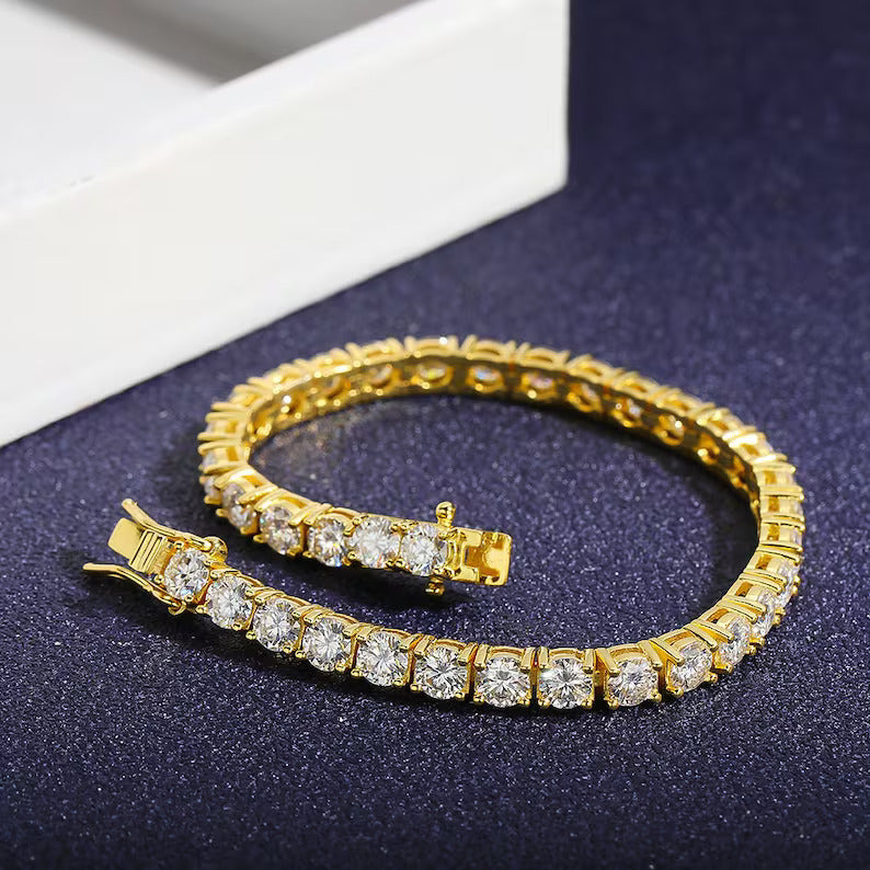 Gold bracelet with clear stones on a dark surface