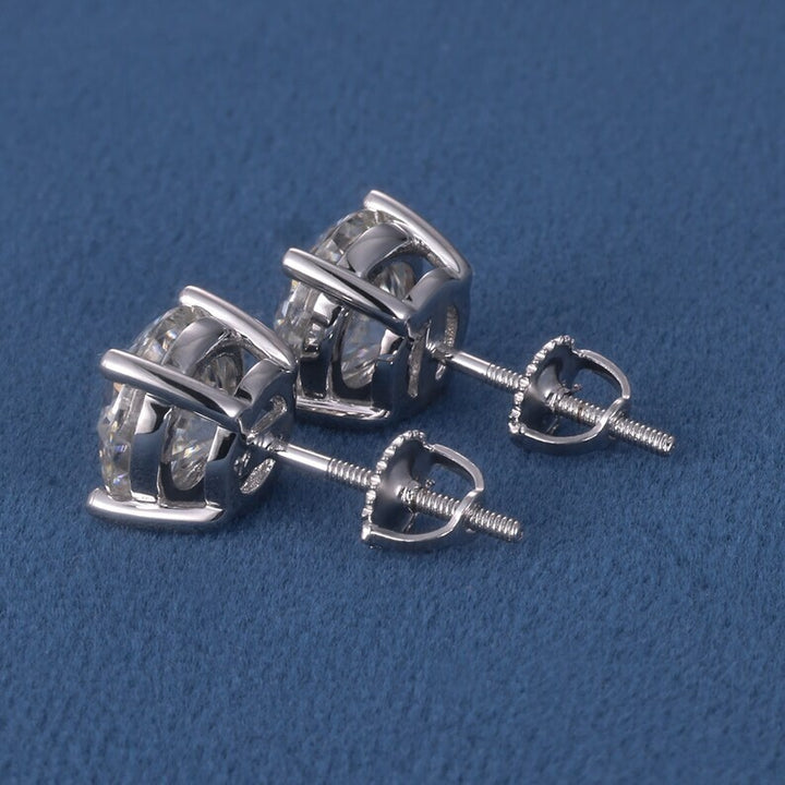 Pair of silver earrings on a blue background