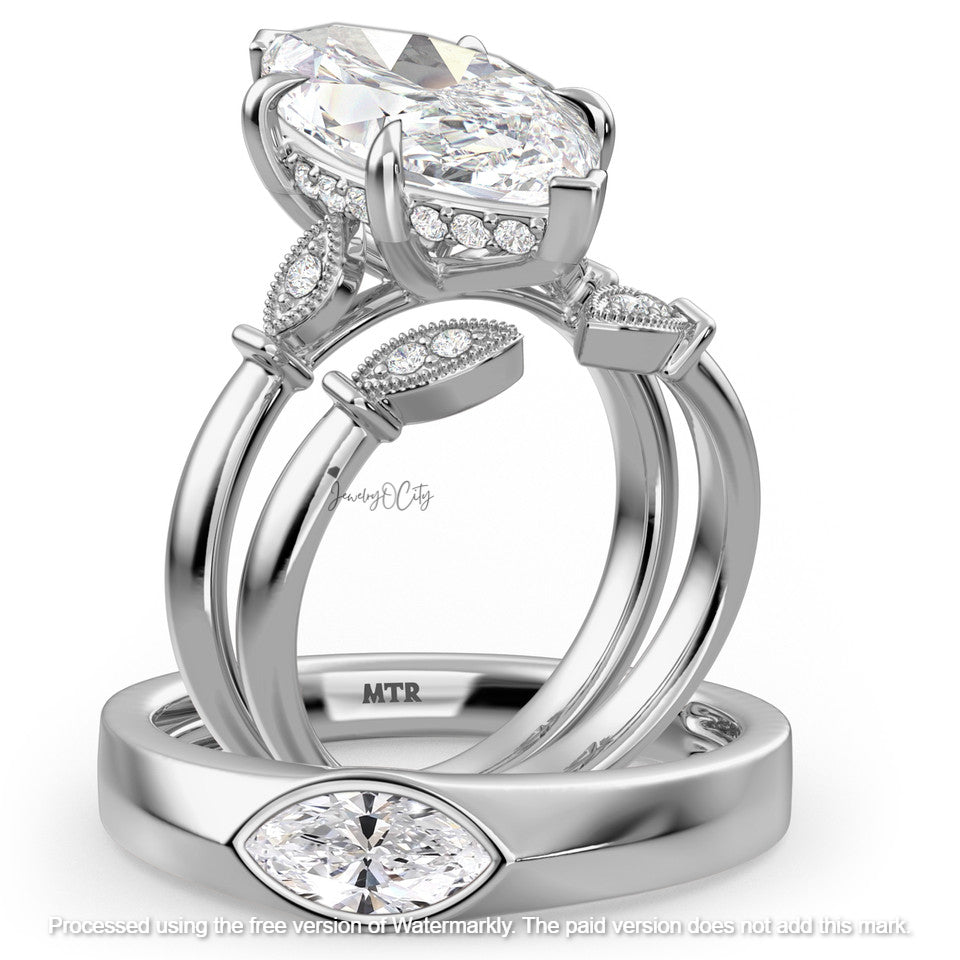 Silver ring with pear-shaped diamond and smaller diamonds on a white background