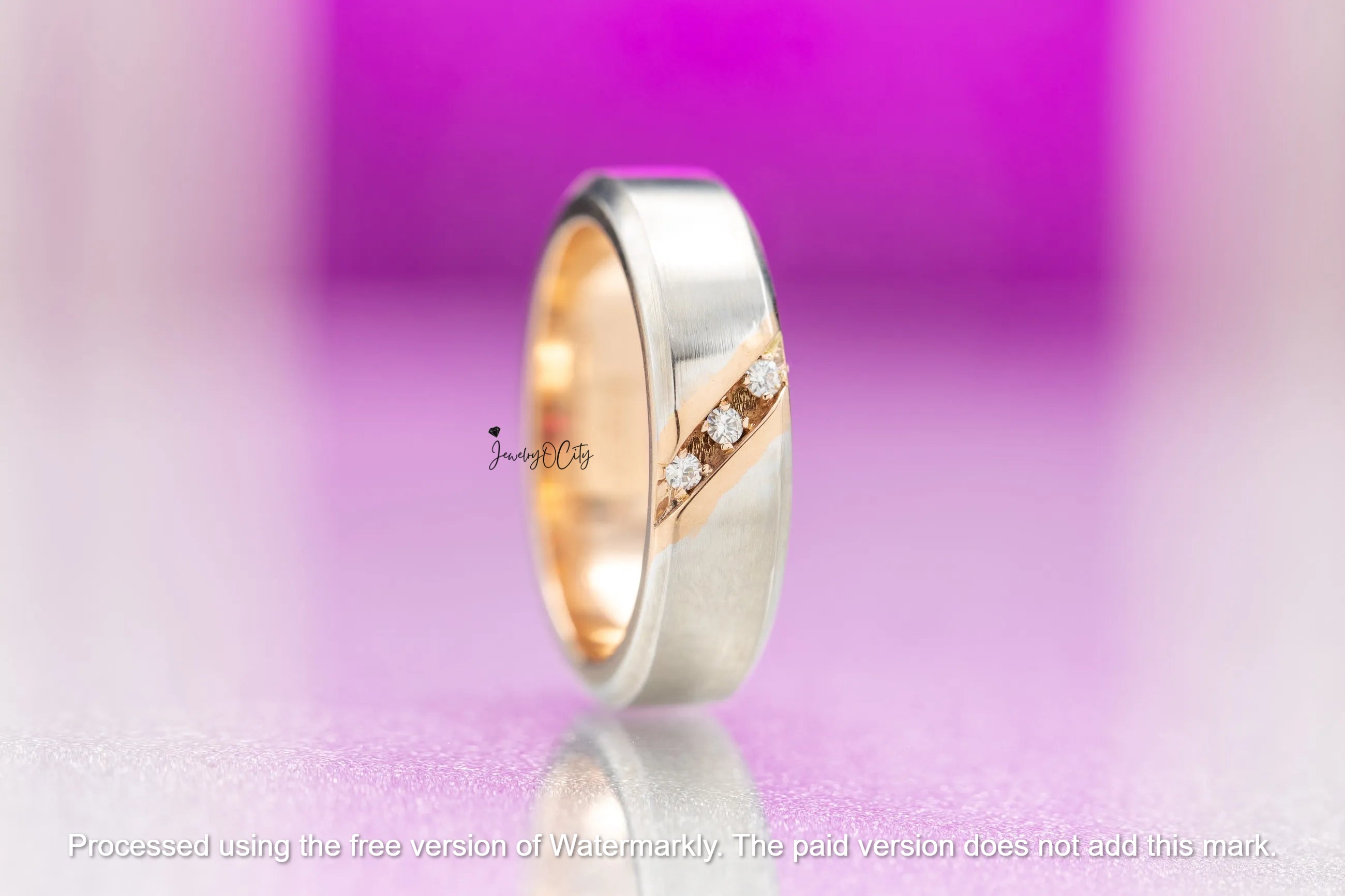 Gold and silver ring with diamonds on a purple gradient background