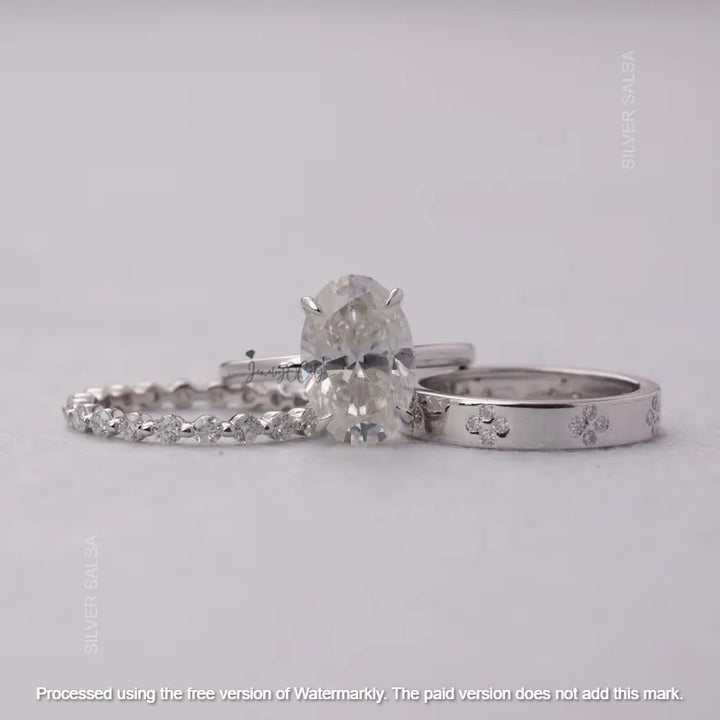 Three silver rings with gemstones on a gray background