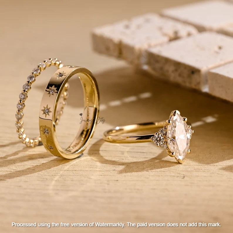 Two gold rings with diamond accents on a wooden surface