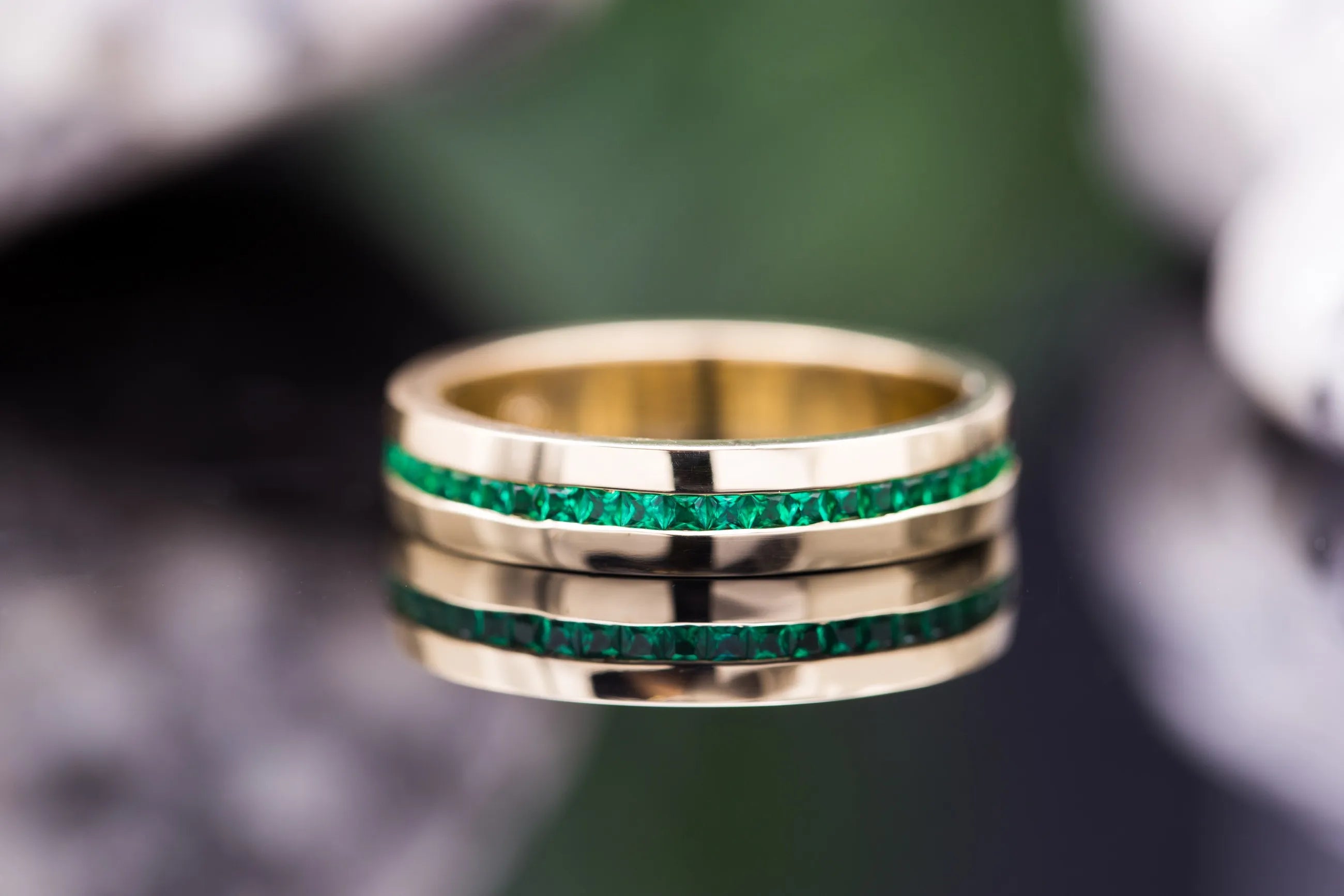 Unisex green emerald wedding band close up