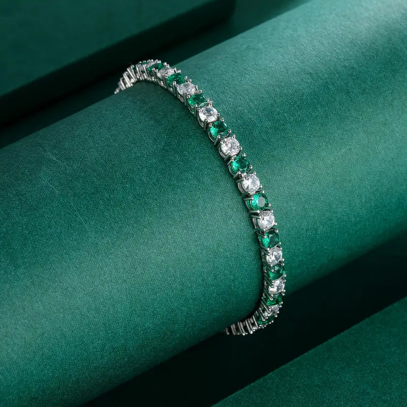 Women's emerald and diamond tennis bracelet close up