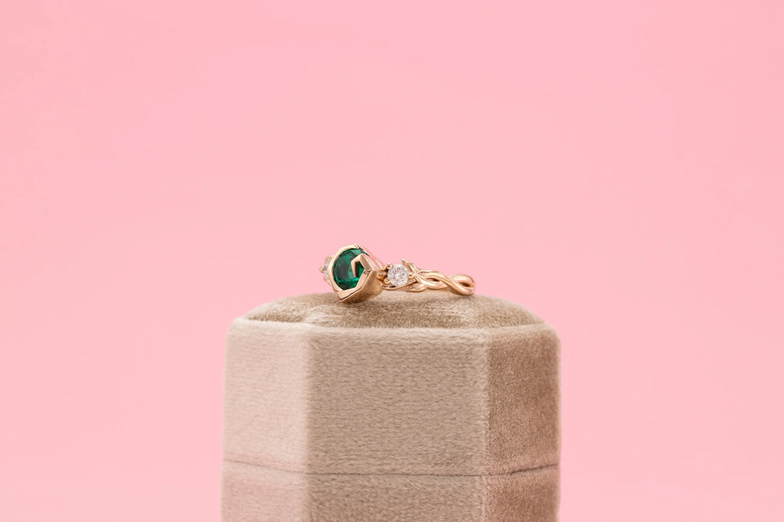 artistic green emerald engagement band