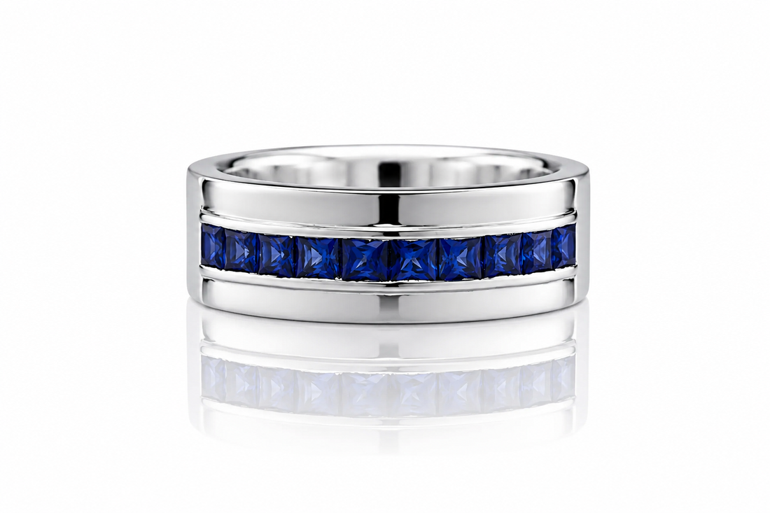Silver ring with blue gemstones on a white background