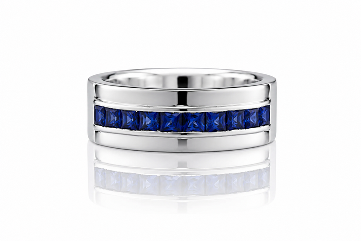 Silver ring with blue gemstones on a white background