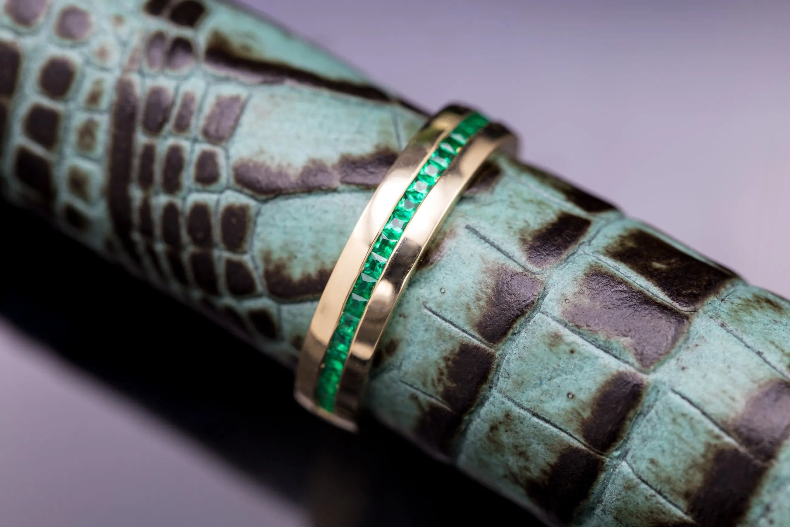 modern emerald engagement band close up